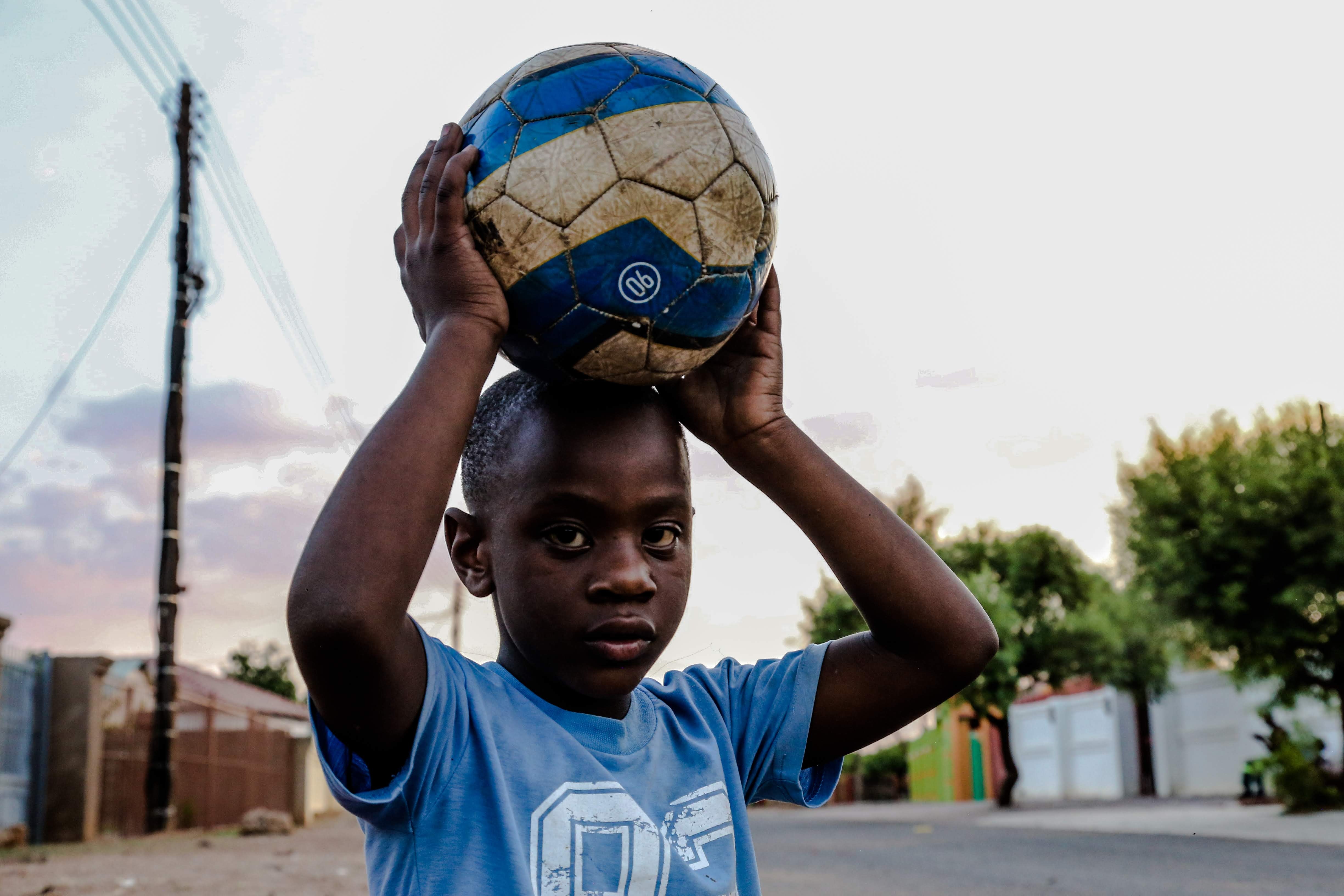 boy-carrying-soccer-ball-on-his-head-1866654